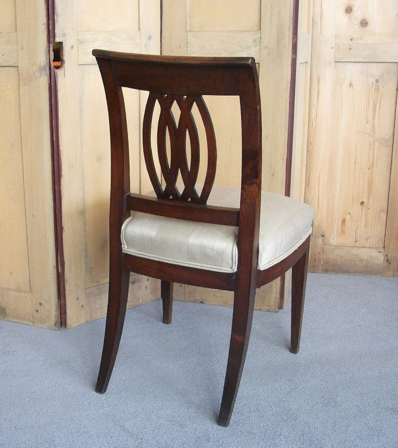 Italian walnut chairs with sabre back legs and decorative pierced back splat. 